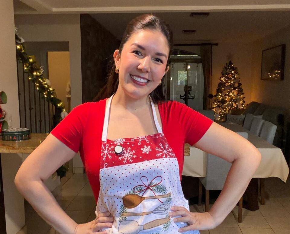 Luci Abarca sonriendo con delantal navideño en una foto de portada para Vlogmas 2025